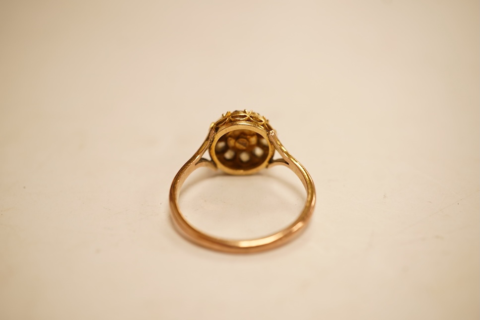 An early 20th century 9ct, cultured pearl and rose cut diamond set circular cluster ring, size O, gross weight 2.8 grams.